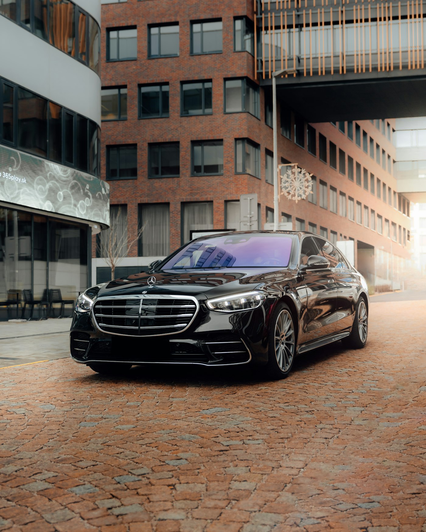 Executive sedan parked outside a city building